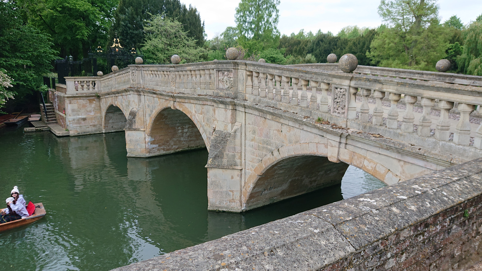 Stone bridge over the River Cam with a punt
