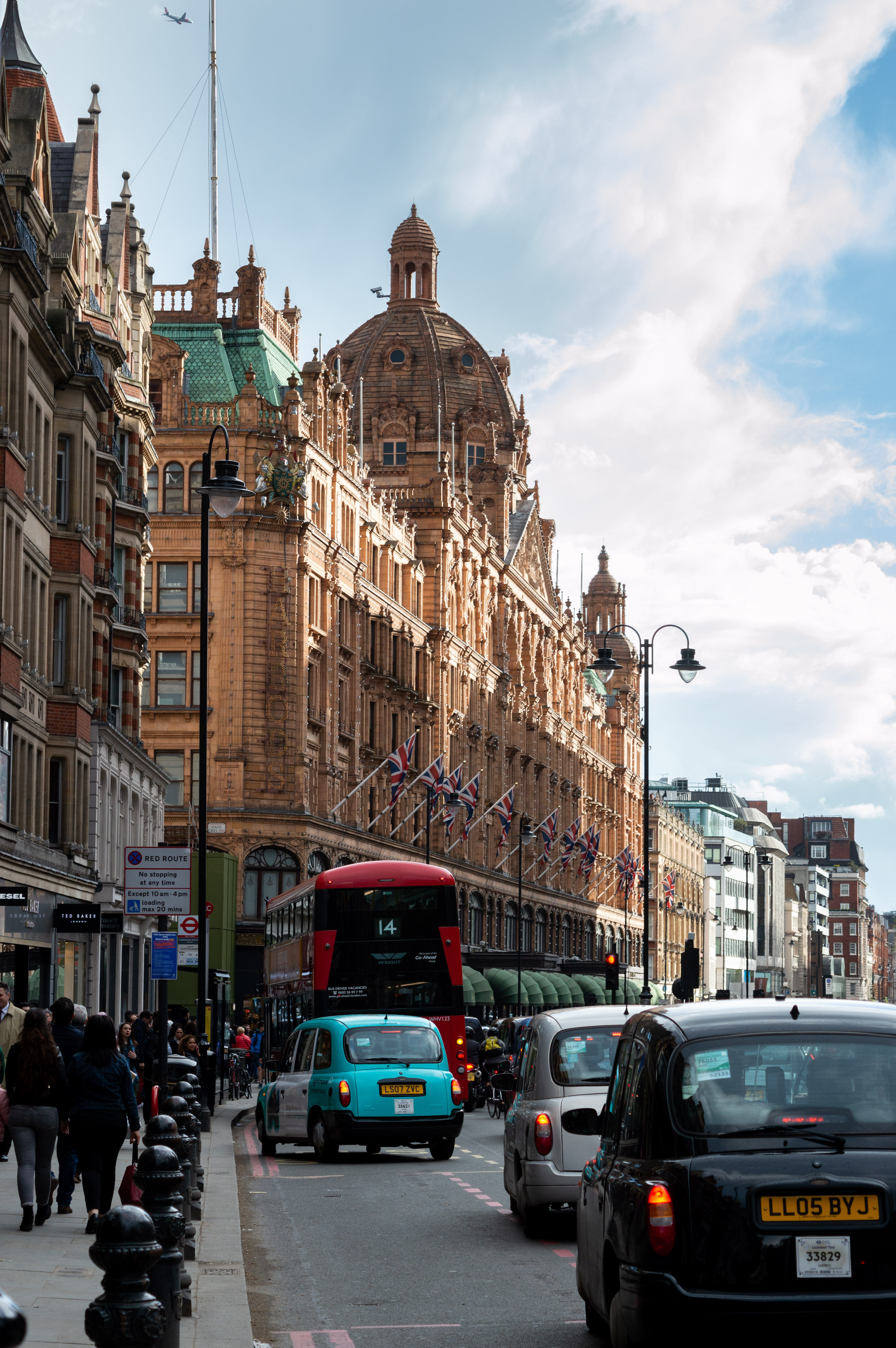 Black cab and red bus outside Harrods in Knightsbridge